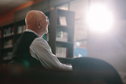 Senior man sitting in classroom
