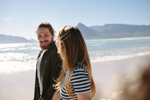 Happy couple strolling on the beach