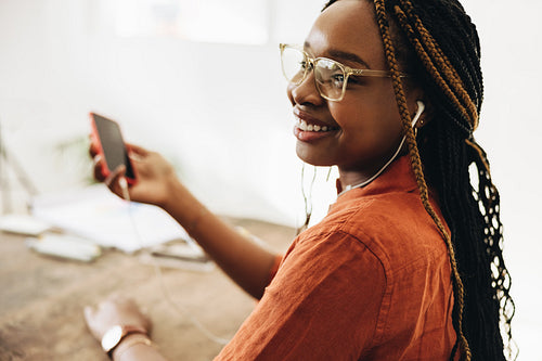 Carefree female freelancer listening to music