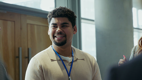 Young professional man laughs and talks during a business networking event