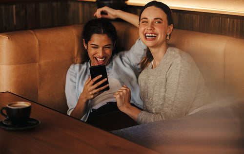 Two women having fun at a cafe