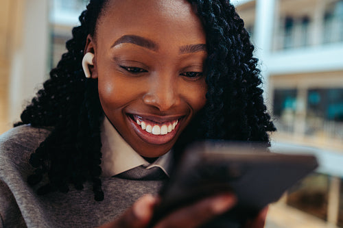 African-American woman using smartphone in office