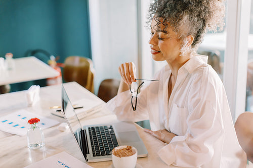 Confident businesswoman working alone in a cafe