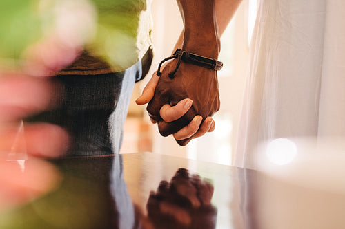 Young man and woman holding hands.