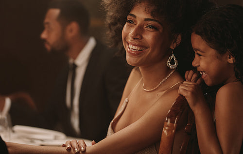 Girl with her mother at gala dinner party