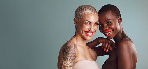 Two beautiful women with short hairstyle smiling together