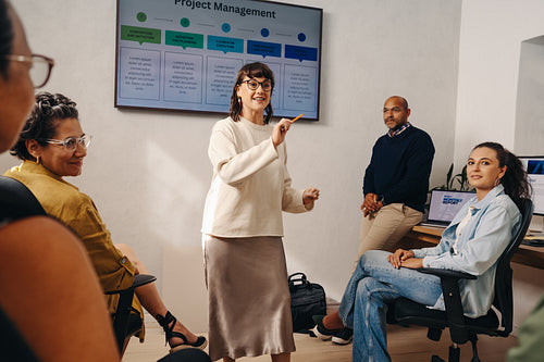 Team collaboration during project management meeting with professional presentation