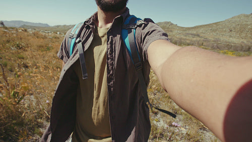 Man taking picture of his friends during hike