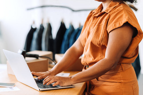 Business owner using a laptop in her shop