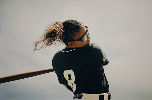 Baseball player executing a powerful swing aiming for a line drive