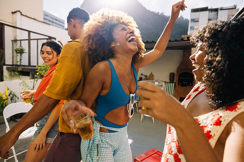 Adults enjoying a joyful gathering outdoors during a sunny summer day