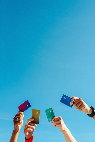 Finance raises credit card hands under a blue sky for students
