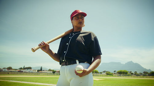 Confident woman ready to play baseball on the field