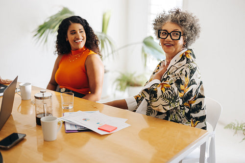 Happy businesswomen sitting in a meeting