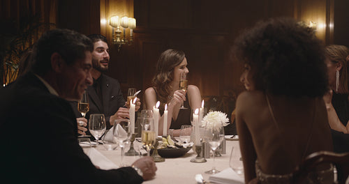 Friends toasting drinks at gala dinner party