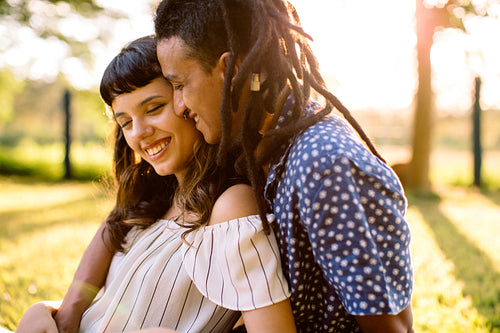 Cute young couple sharing an intimate moment together outdoors