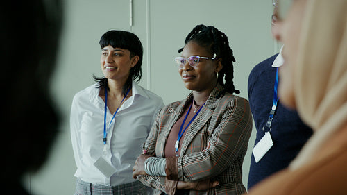 Diverse business professionals sharing a laugh and connecting at a professional conference