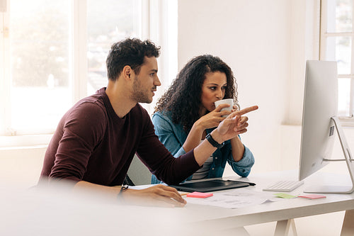 Business colleagues sitting together and discussing work in office