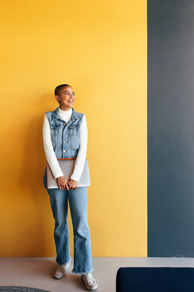 Millennial businesswoman laughing happily in an office