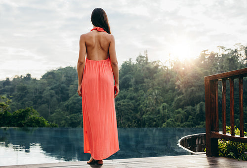 Woman at poolside of a luxury resort