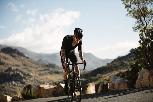 Cyclist charges up steep mountain road