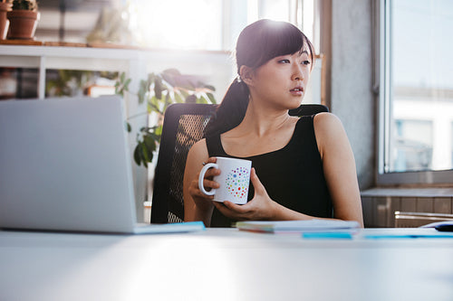 Business woman taking coffee break in office