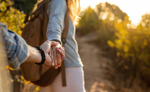 Hiking couple holding hands 