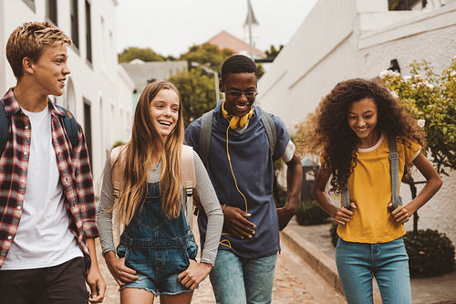 Friends walking together in an alley