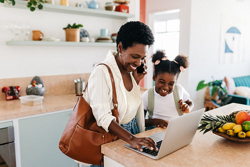 Busy mom's morning: Woman making a work call during family morning routine