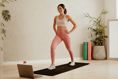 Woman fitness instructor teaching from studio virtually