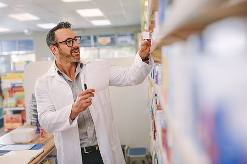 Pharmacist looking for medicine in the store