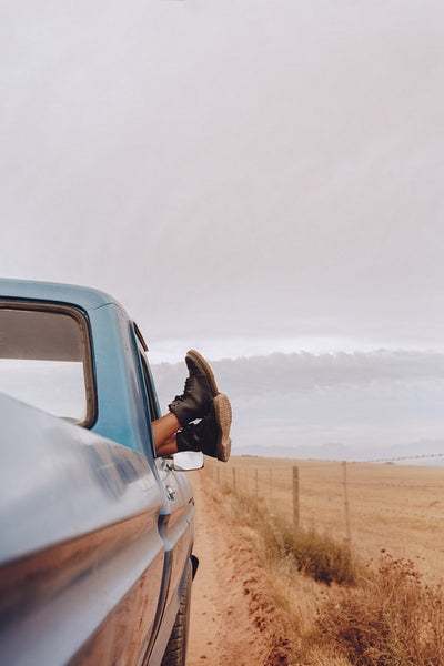 Woman relaxing in a car on road trip