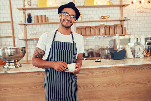 Happy young barista at work