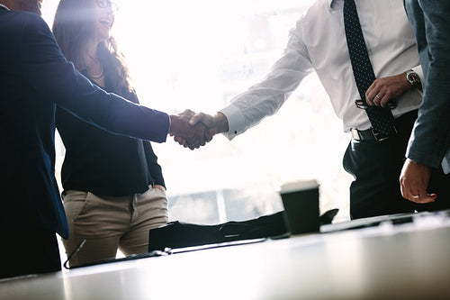 Business men shaking hands with each other after a deal