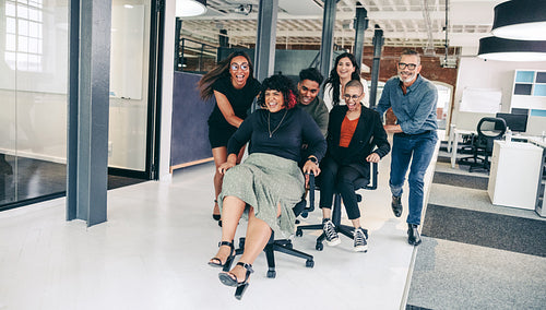 Playful businesspeople having fun in the office