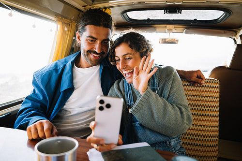 Couple on a road trip in a van on a video call