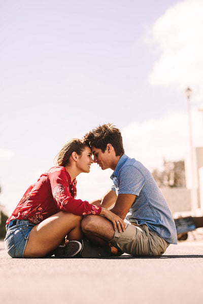 Couple sitting together on an empty street