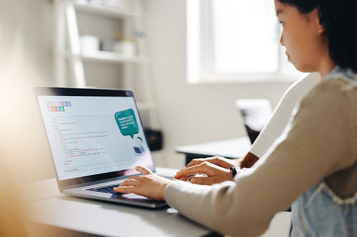 Coding for children: Young girl programmes with a laptop in a computer science class