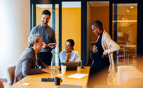 Group of colleagues sharing ideas during a meeting in a bright office