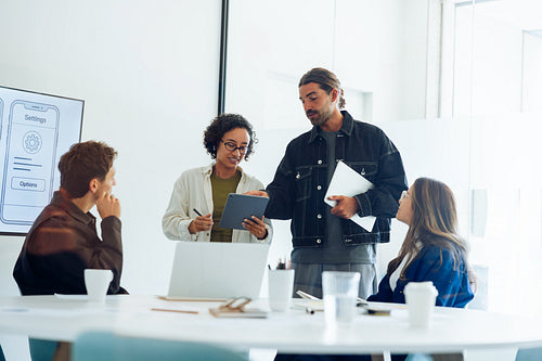 Man and woman lead design team meeting
