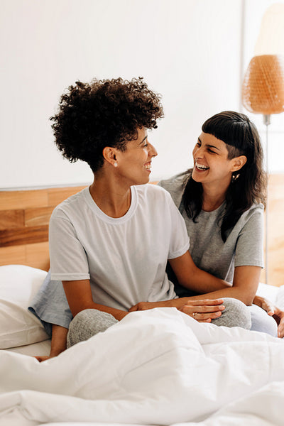 LGBTQ+ couple laughing together at home
