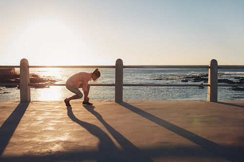 Young woman getting ready to start running workout 
