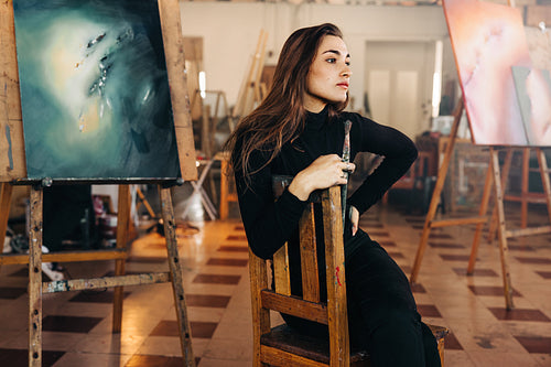 Art professional thinking of new ideas in her workshop