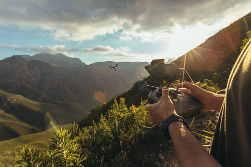 Hiker flying drone above nature reserve