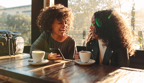 Two women having fun at a coffee shop