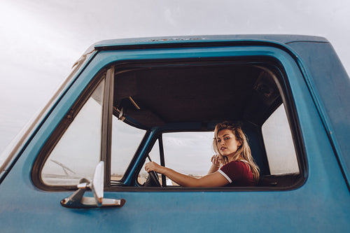 Woman traveling by a car on road trip