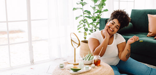 Smiling woman doing skincare routine at home