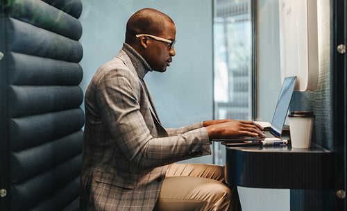 Young business man working on laptop in coworking office