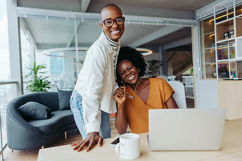 Two successful businesswomen collaborating in a creative startup company