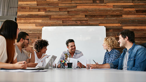 Happy young business people meeting in conference room